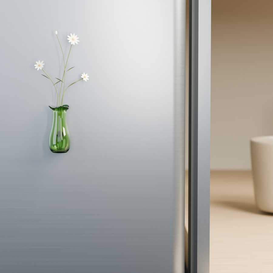 A single green glass vase holding white daisy stems on a fridge